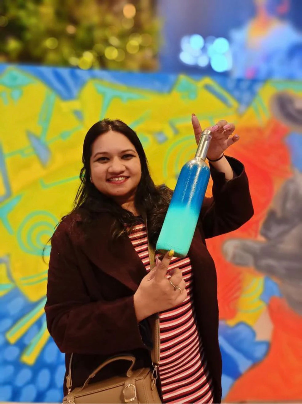 Girl with glass bottle using cosmos spray paints
